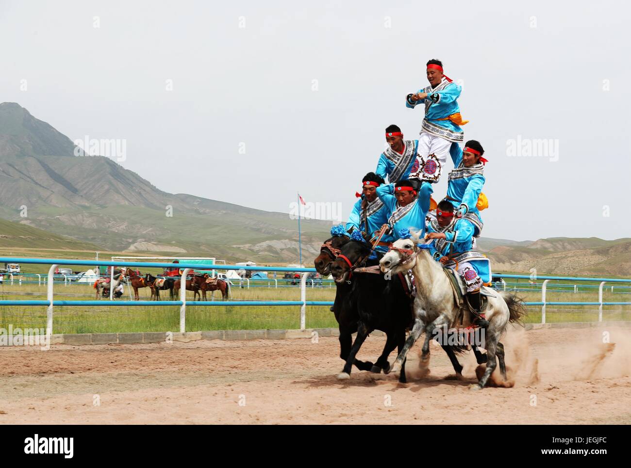 Zhangye, China's Gansu Province. 24th June, 2017. Competitors perform human pyramid on horseback during a horse racing event in Sunan County, northwest China's Gansu Province, June 24, 2017. Credit: Cheng Lin/Xinhua/Alamy Live News Stock Photo