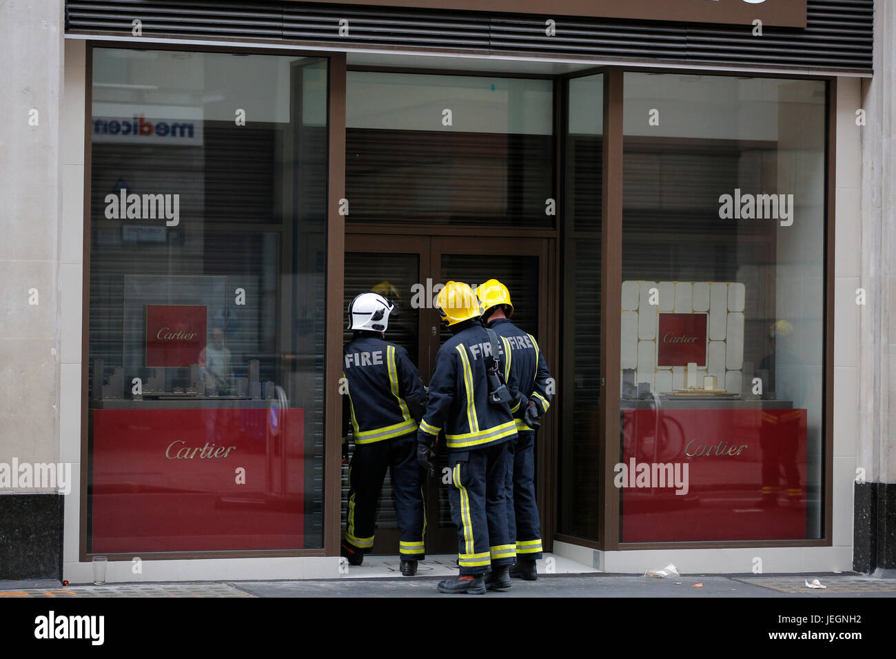 London, UK. 25th Jun, 2017. Firefighters and police responding to alarm sound outside Ernest Jones jewelry magazine on Cheapside near Bank station at City of London. Fire engines parked outside the shops and police suspending traffic on Cheapside. Nearby people watching police and firefighters gathering outside Ernest Jones shop. Loud alarm is heard around area. Fire engines were the first ones to respond as police arrived few minutes later. Everything looks safe from outside no visible fire to see or no smoke to see anywhere in the area. Credit: Antanas Martinkus for CTJA/Alamy Live News Stock Photo