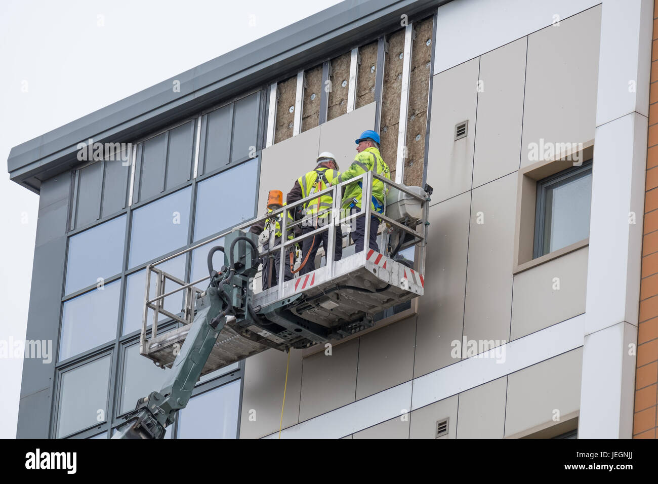 Bootle, Merseyside, UK. 25th June, 2017. Two high-rise blocks on St James Drive in Bootle, Merseyside failed fire safety tests carried out this week. On Sunday June 25, 2017, contractors are removing cladding after the landlord instructed the cladding to be removed immediately. There has been no evacuation of the affected tower blocks. Credit: Christopher Middleton/Alamy Live News Stock Photo