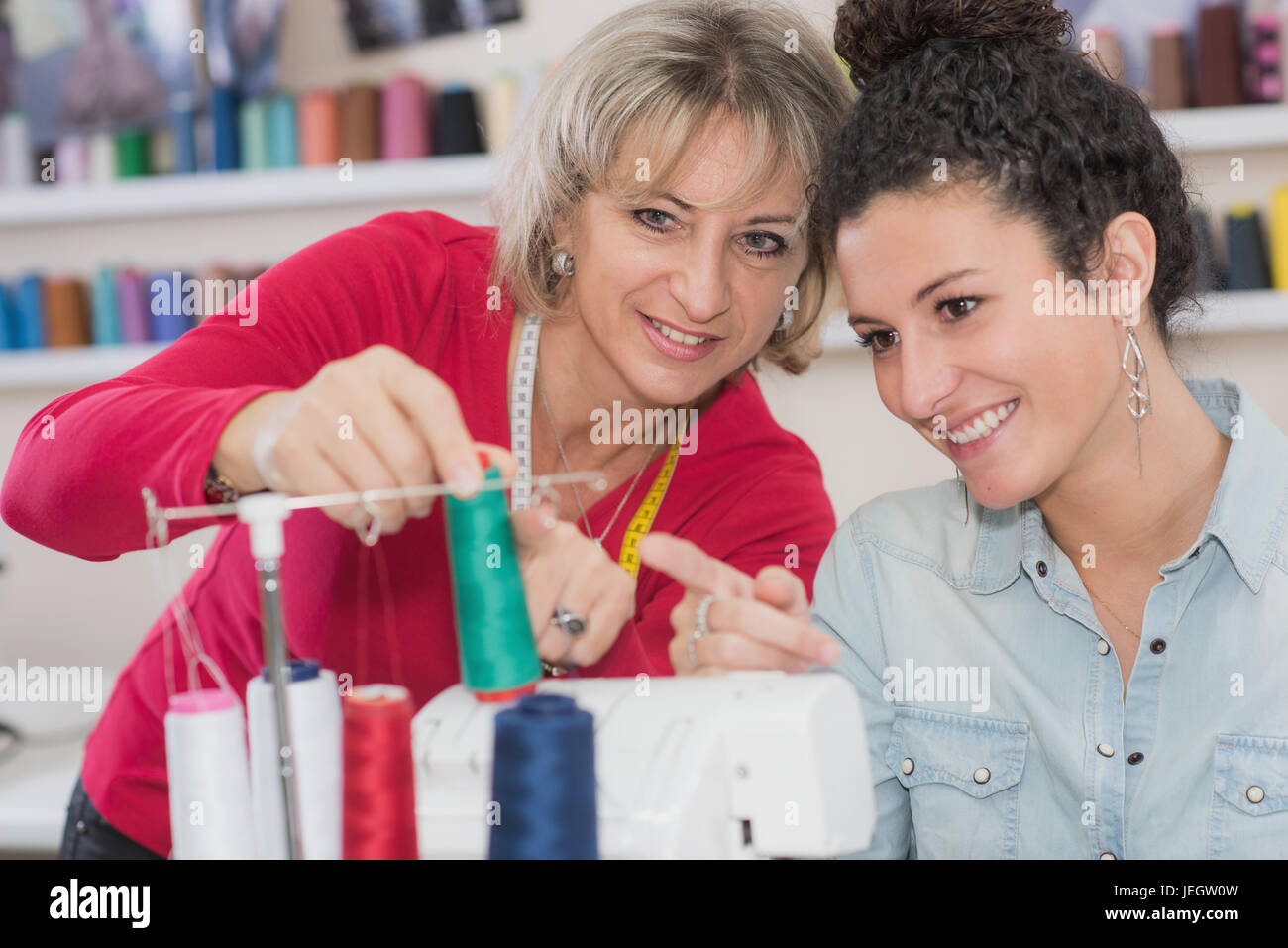 dressmaker couple is working with the sewing machine Stock Photo Alamy