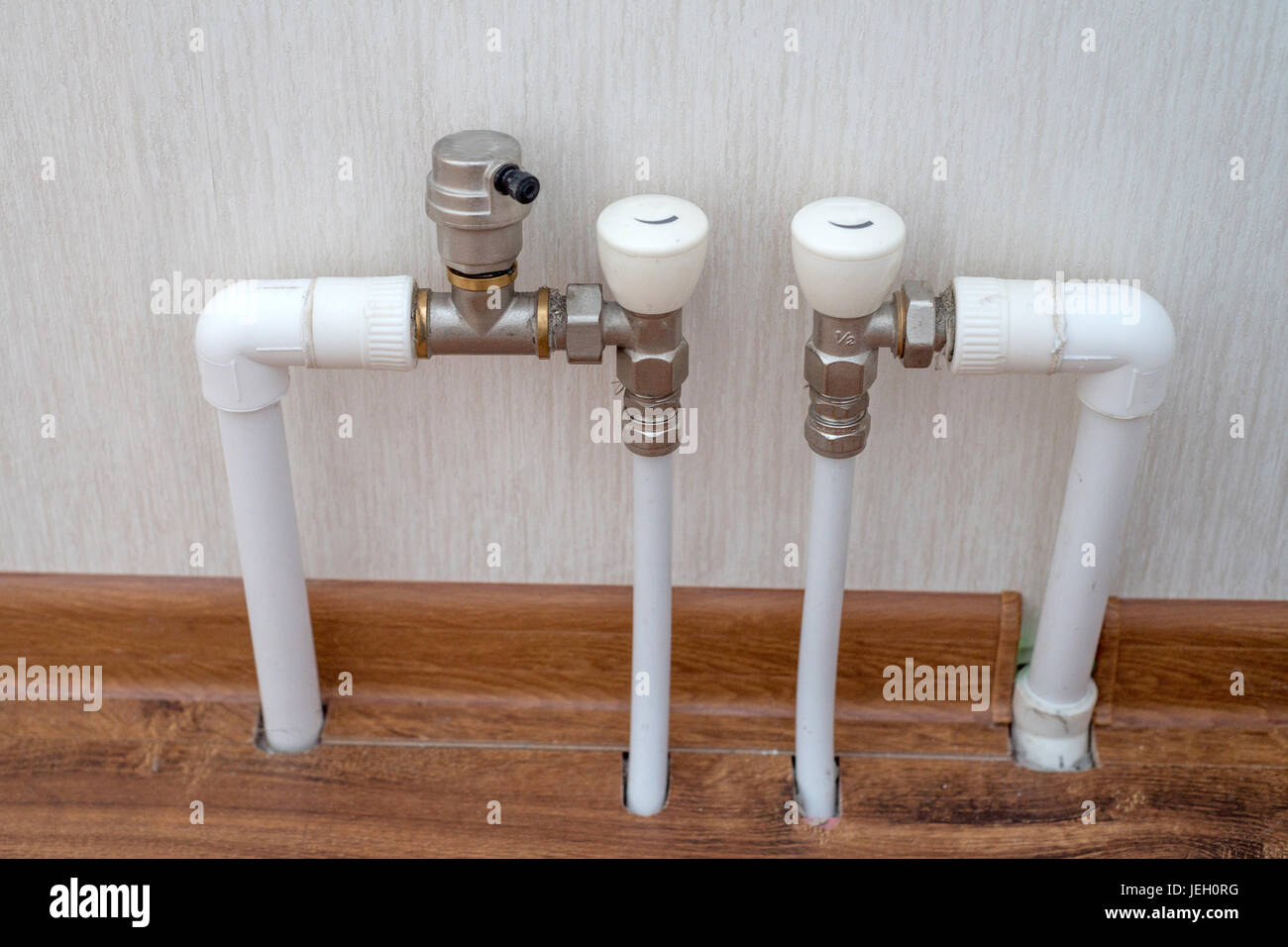 Floor heating pipes and taps Stock Photo Alamy