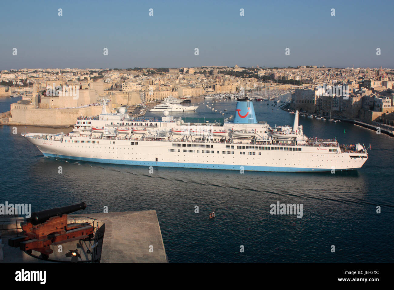 The cruise ship or liner Thomson Spirit departing from Malta's Grand Harbour. Holiday travel in the Mediterranean Sea. Stock Photo