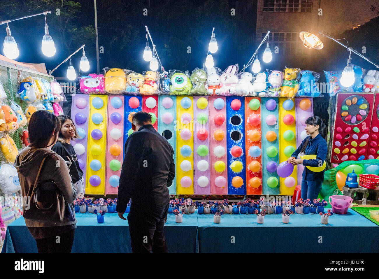 TAIPEI, TAIWAN - MAY 20: This is a game in Shilin night market where people can win soft toys by hitting balloons with darts it is a common game acros Stock Photo