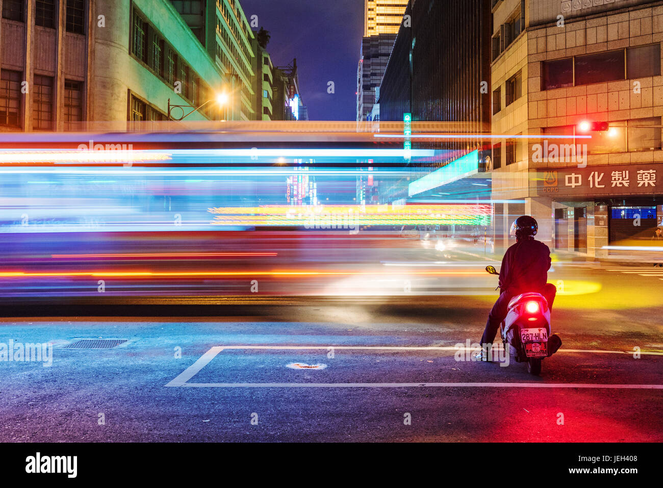 TAIPEI, TAIWAN - MAY 27: This is a night view of motorcyclist waiting at traffic lights for the light to change to green in the downtown area on May 2 Stock Photo