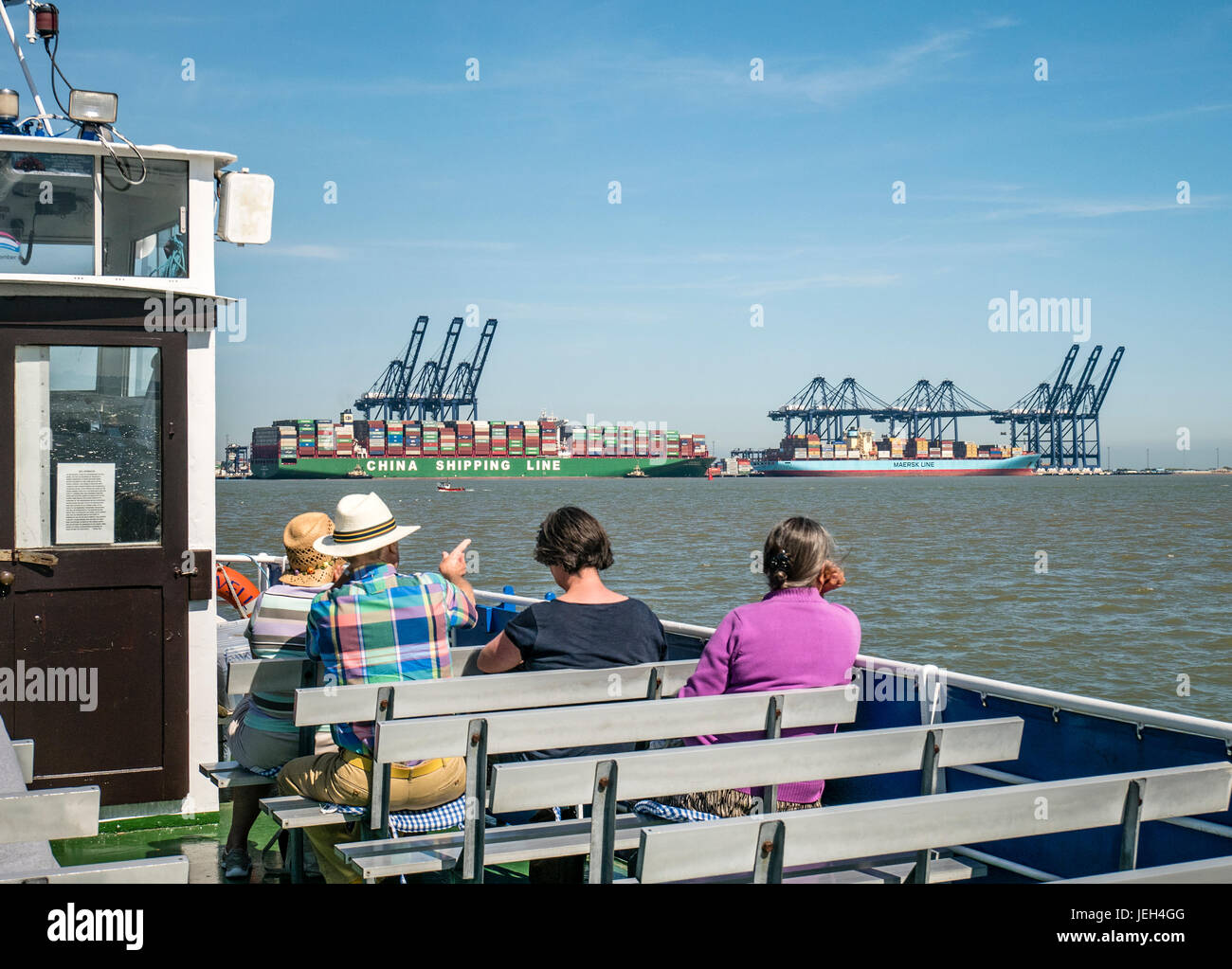Tourists on River Orwell Cruise viewing Container Ships in the Port of Felixstowe Suffolk UK Stock Photo
