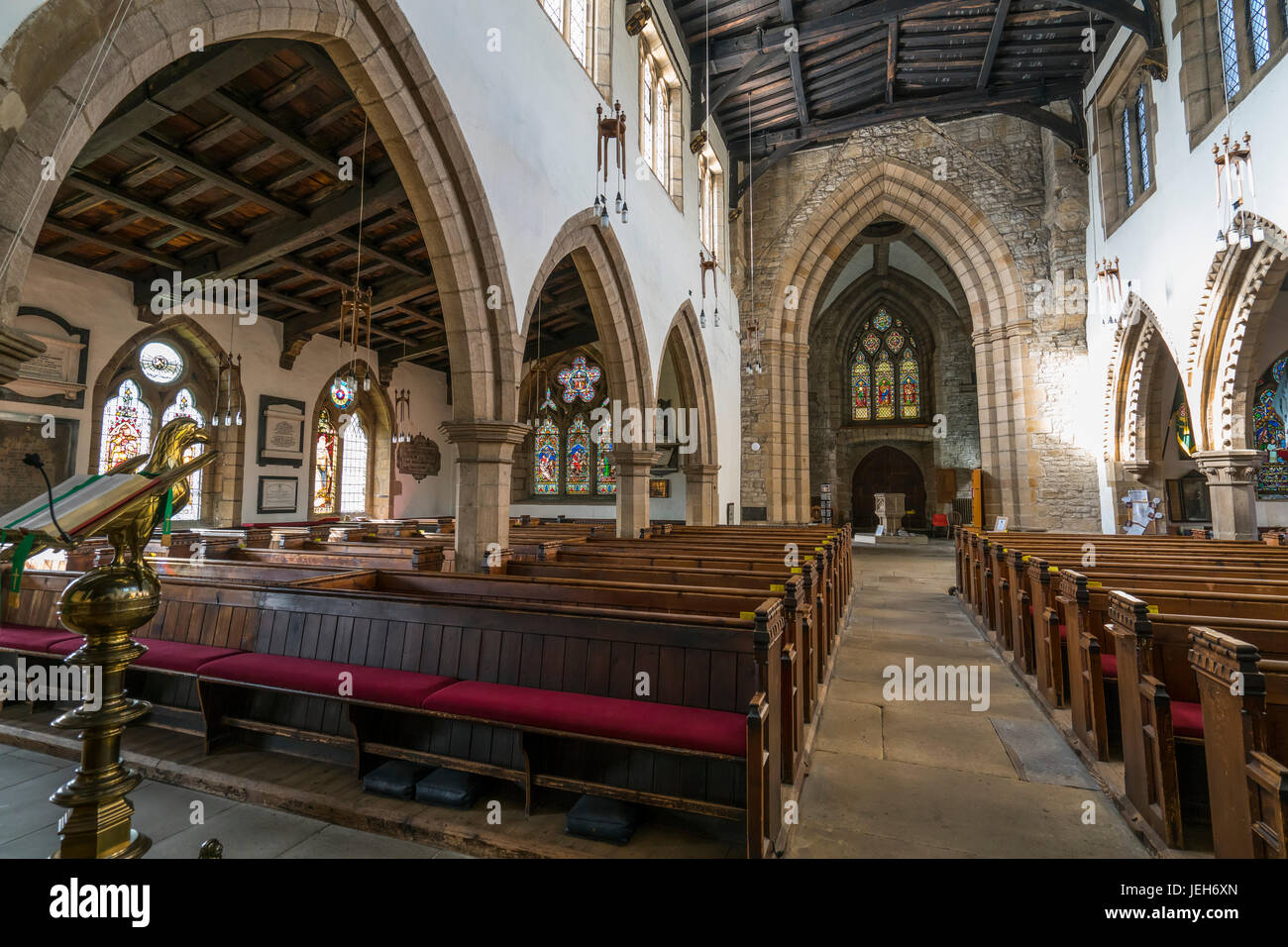 Interior of a church viewed from the altar, with wooden pews and arches; Yorkshire, England Stock Photo