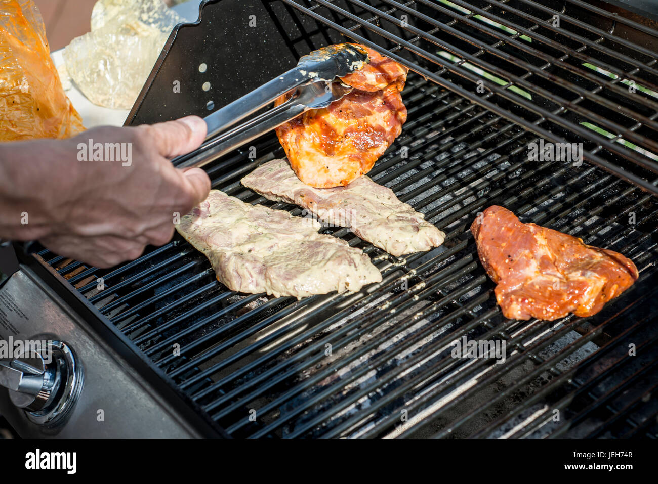 Barbecue grill bbq on propane gas grill. steaks bratwurst sausages meat
