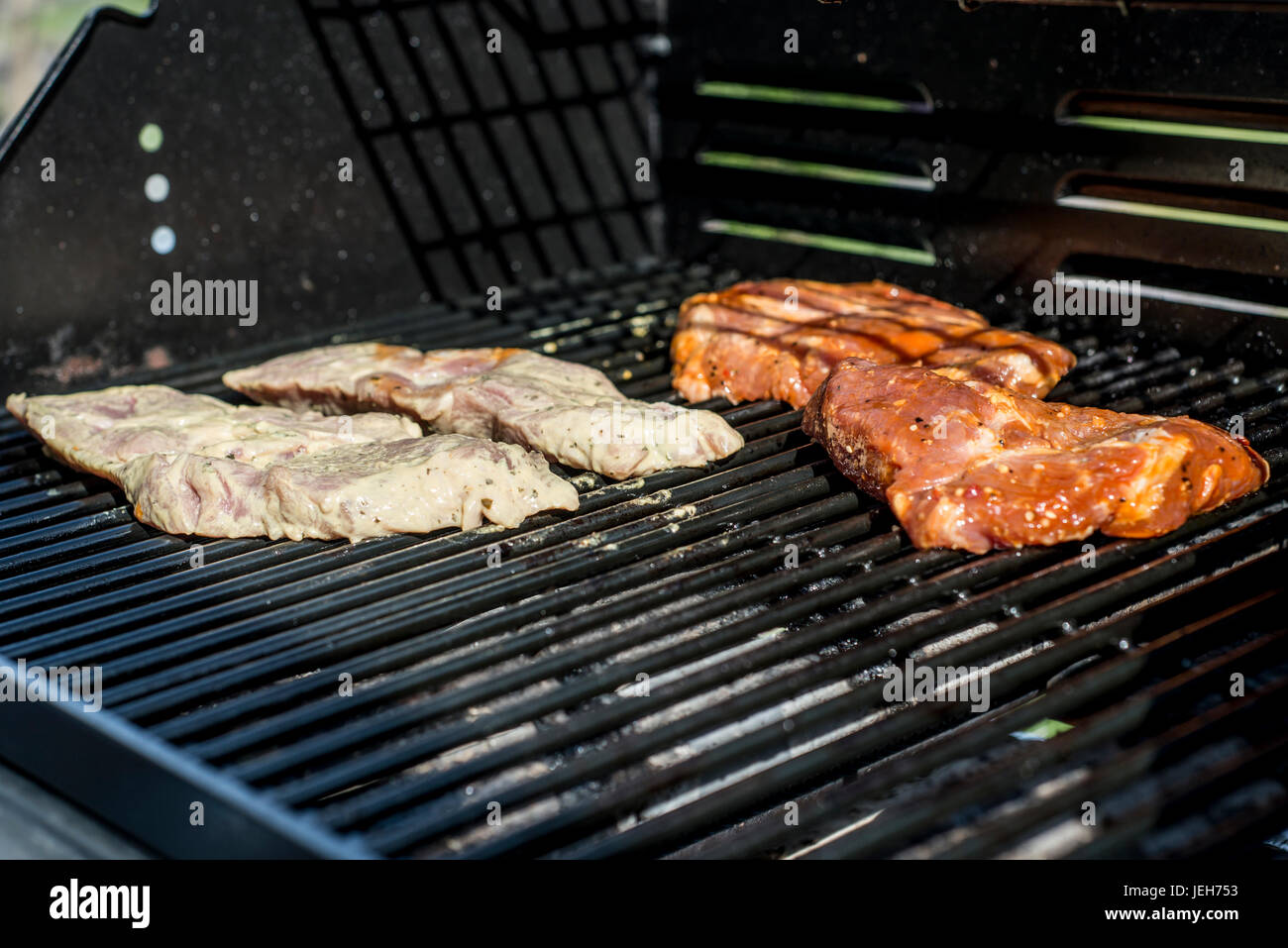 Barbecue grill bbq on propane gas grill. steaks bratwurst sausages meat