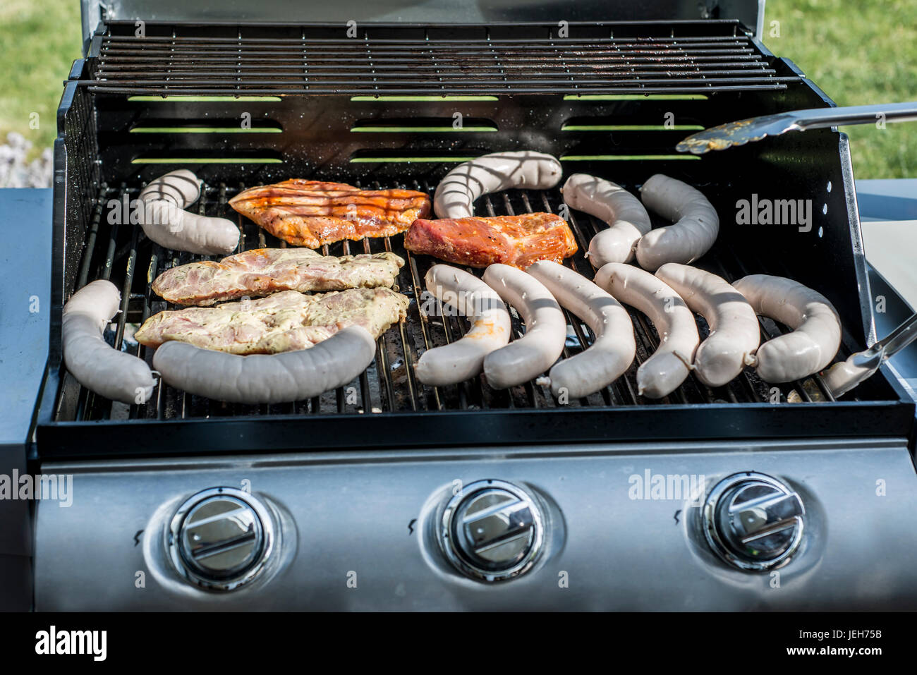 Barbecue grill bbq on propane gas grill. steaks bratwurst sausages meat