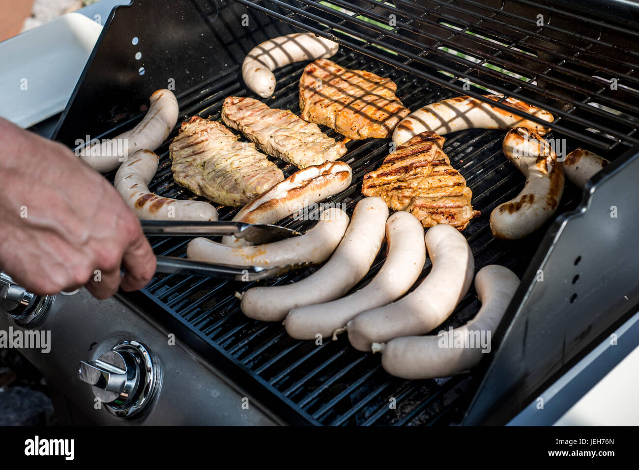 Barbecue grill bbq on propane gas grill. steaks bratwurst sausages meat  meal Stock Photo - Alamy