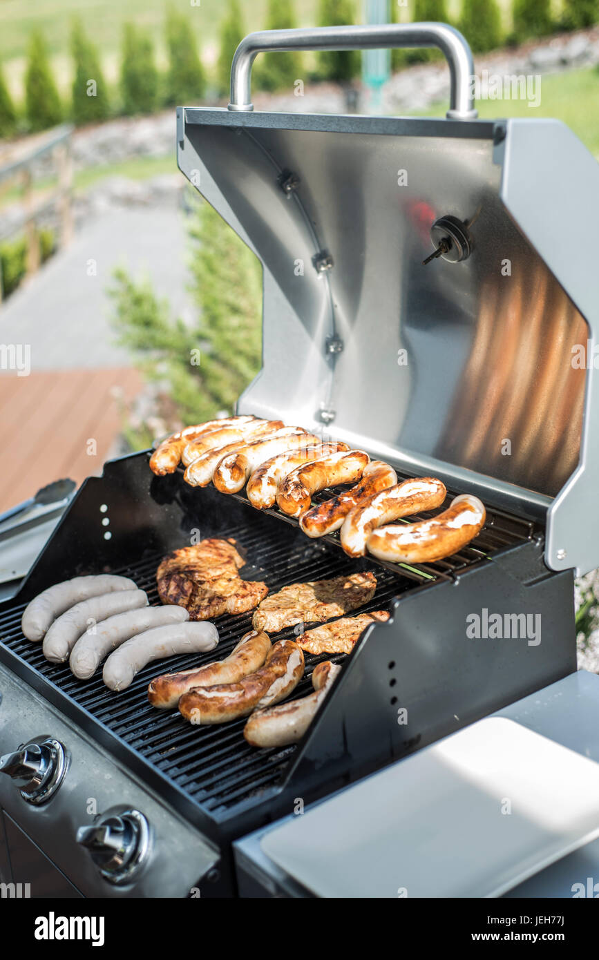 Barbecue grill bbq on propane gas grill. steaks bratwurst sausages meat