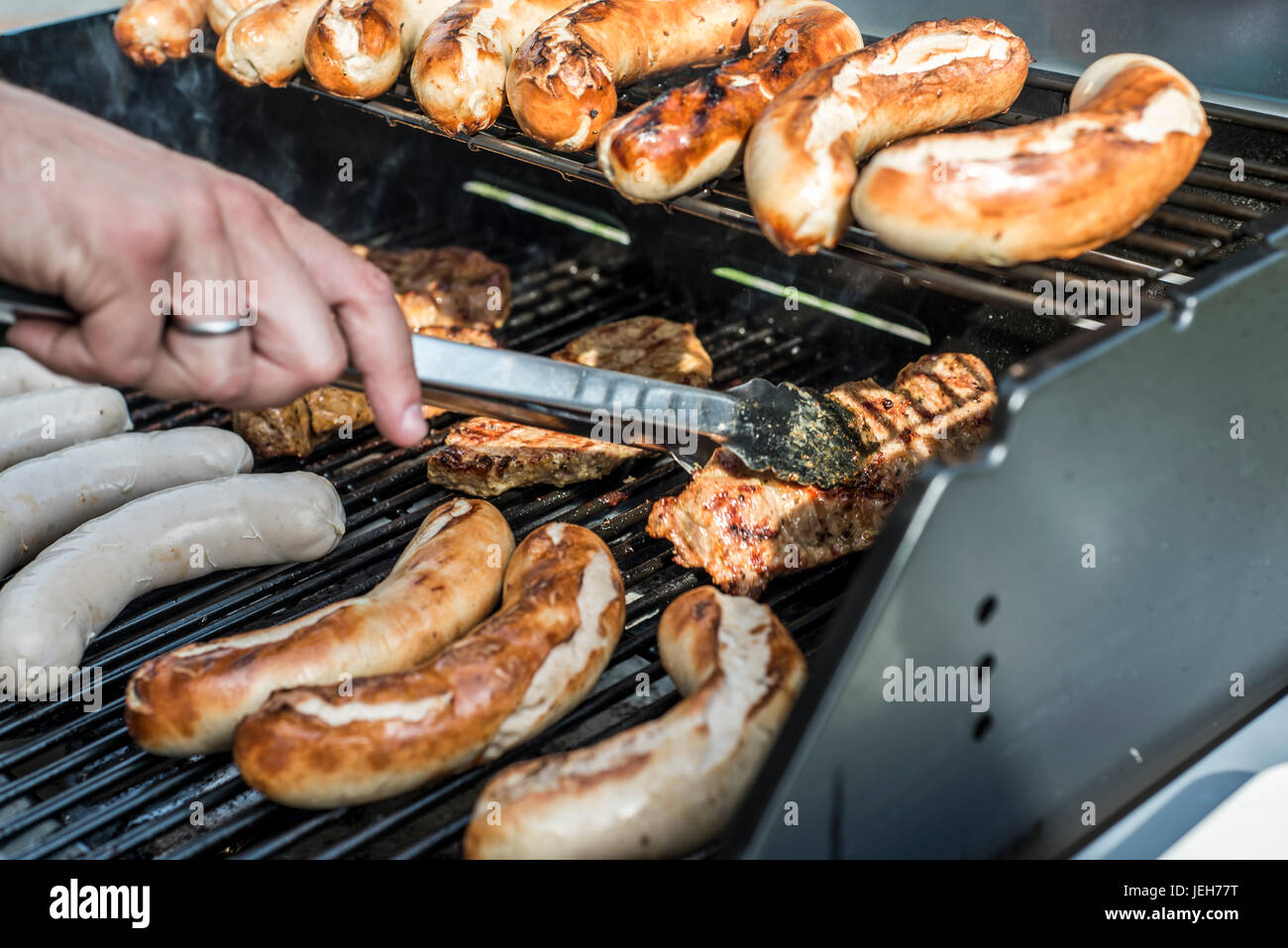 Barbecue grill bbq on propane gas grill. steaks bratwurst sausages meat
