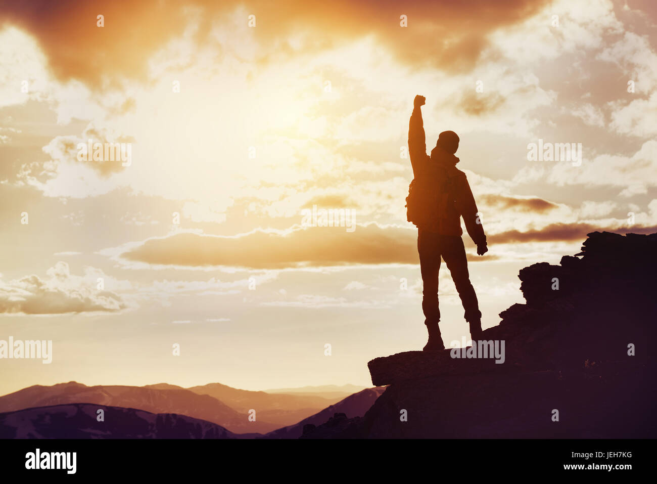 Man winner mountain top silhouette Stock Photo