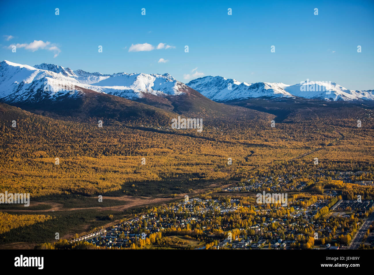 Eagle River Valley, Homes Nestled Among The Trees In The Foreground, Autumn Coloured Trees Filling The Valley, Snow Covering The Chugach Mountains ... Stock Photo