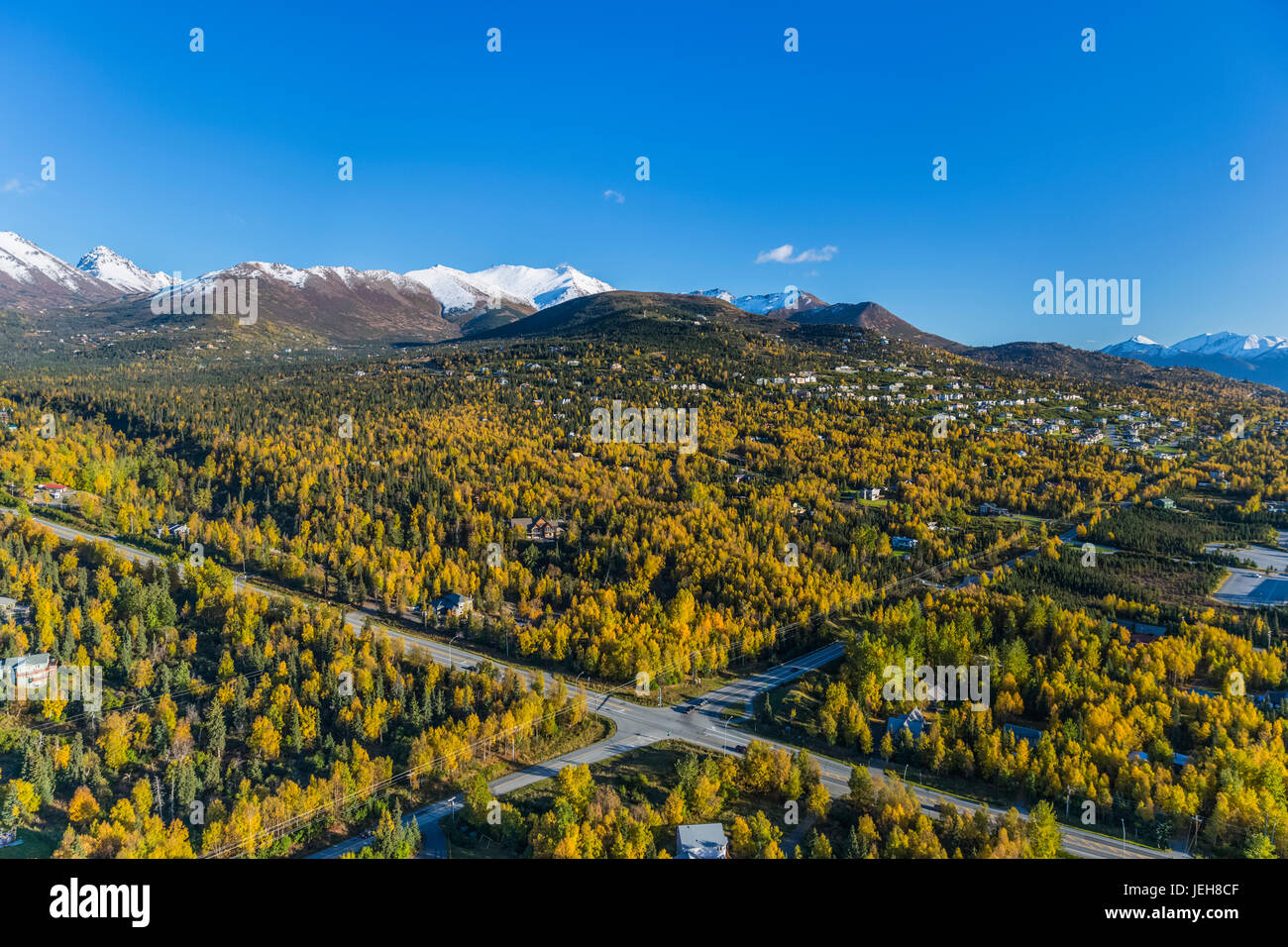 Aerial View Of The Hillside Neighbourhood Homes In Anchorage, Snow Covering The Peaks Of The