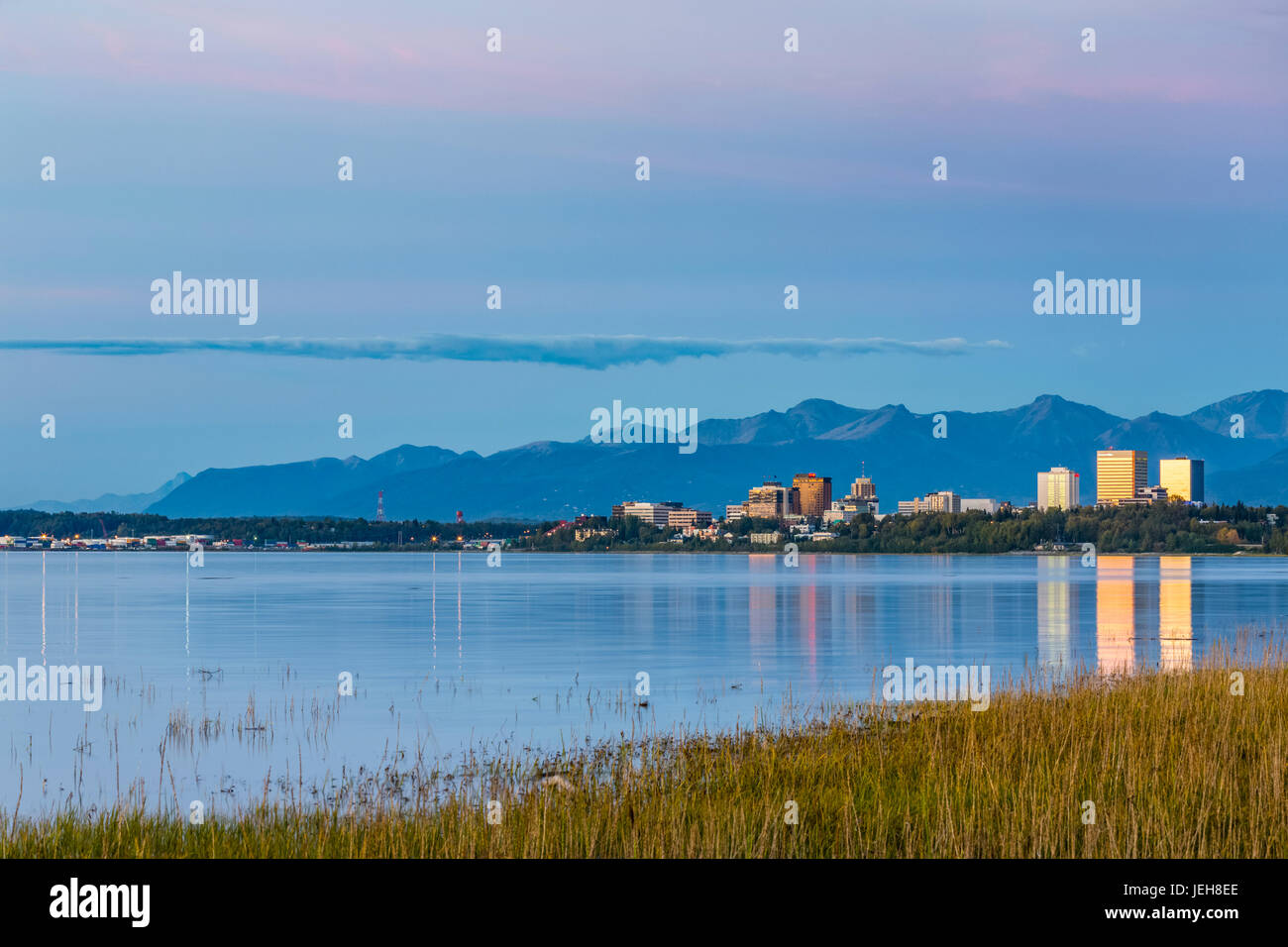 The Setting Sun Reflects Off Of Office Buildings In Downtown Anchorage