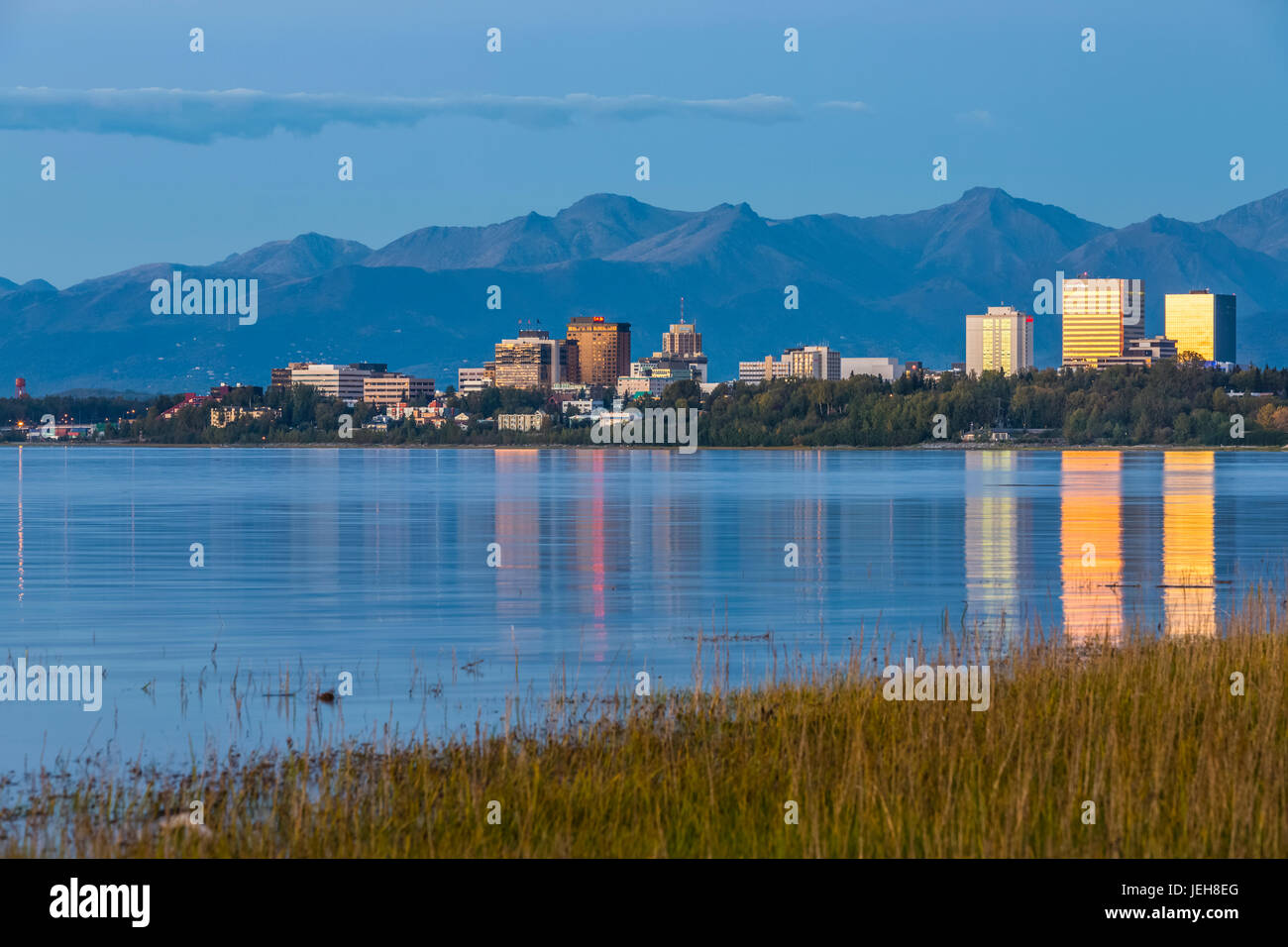 The Setting Sun Reflects Off Of Office Buildings In Downtown Anchorage