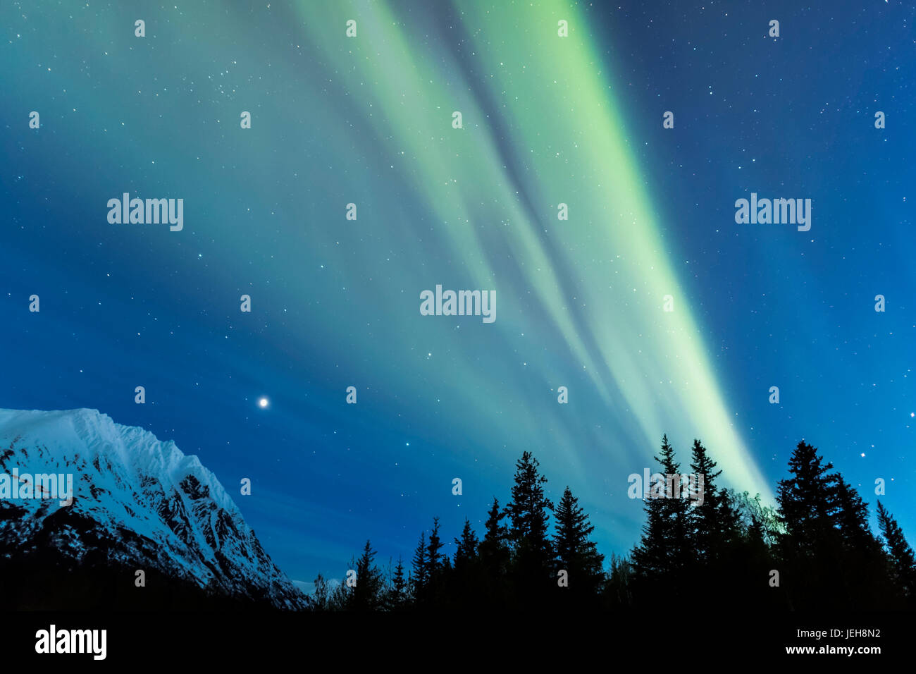 Faint green Aurora Borealis dances over the Kenai Mountains, Moose Pass