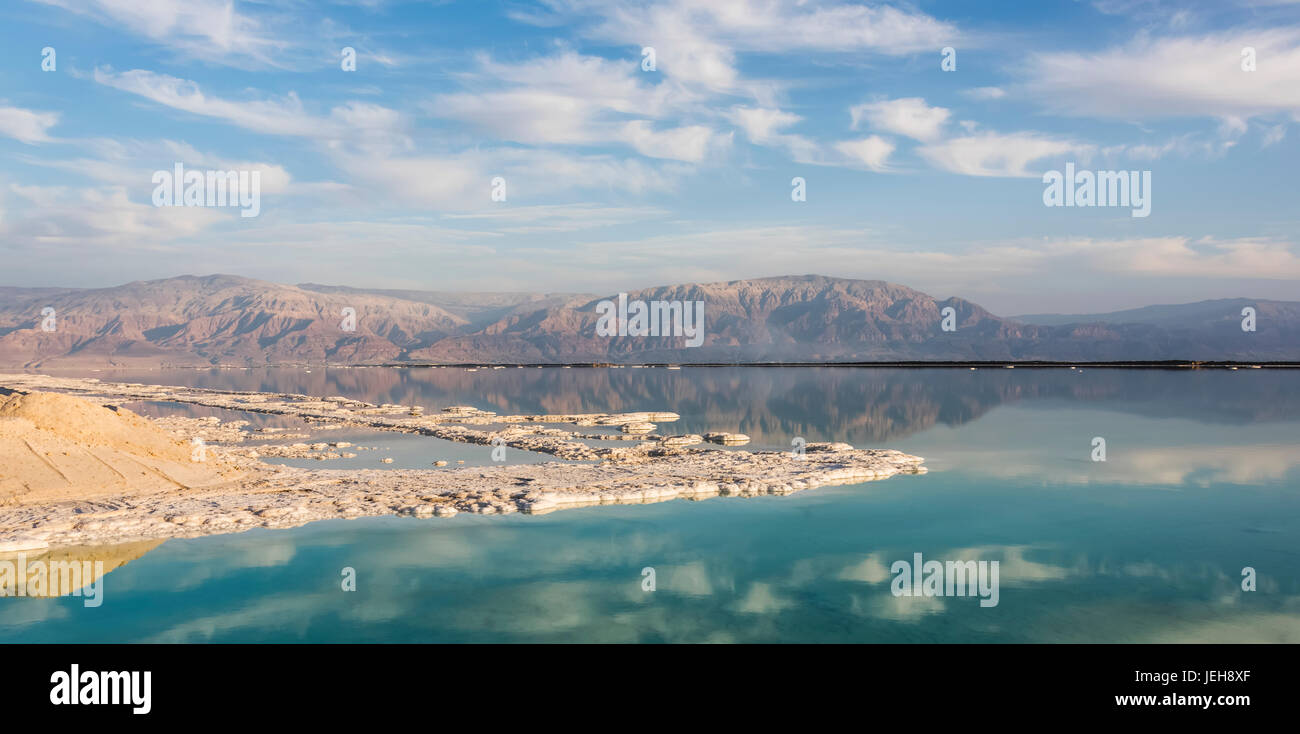 The sky and mountains of the Judean Desert reflected in the tranquil water of the Dead Sea; South District, Israel Stock Photo