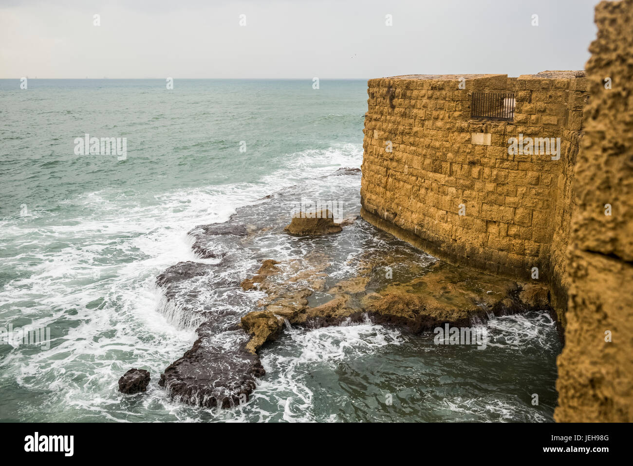 Stone wall along the water's edge with a view of the Mediterranean Sea; Haifa District, Israel Stock Photo