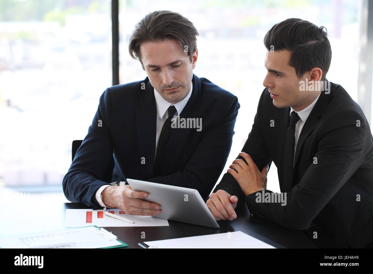Business people using tablet pc together at office Stock Photo