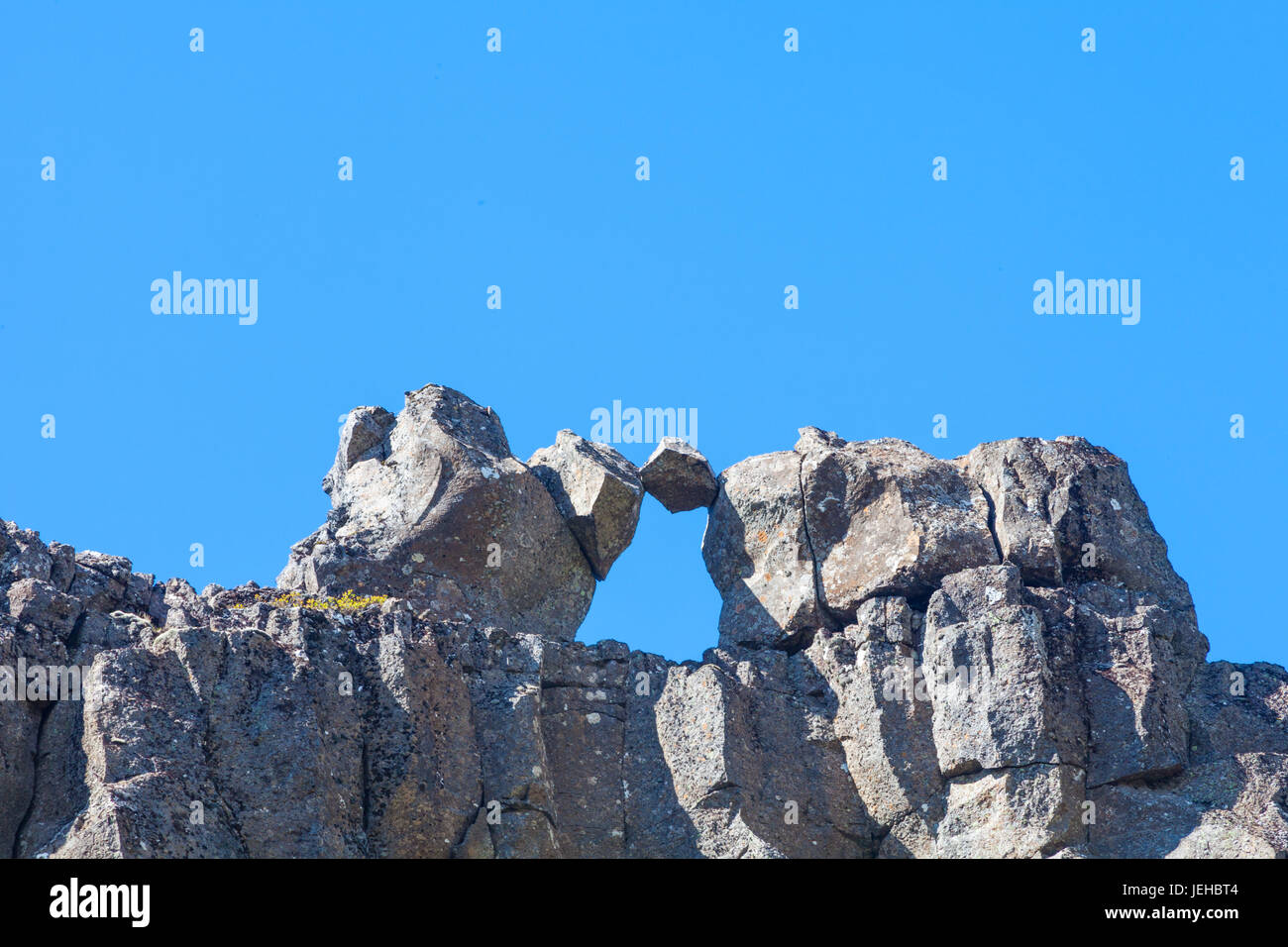 Fragment of Basalt rock held between rocky protrusions at the mid-Atlantic Ridge in Iceland Stock Photo