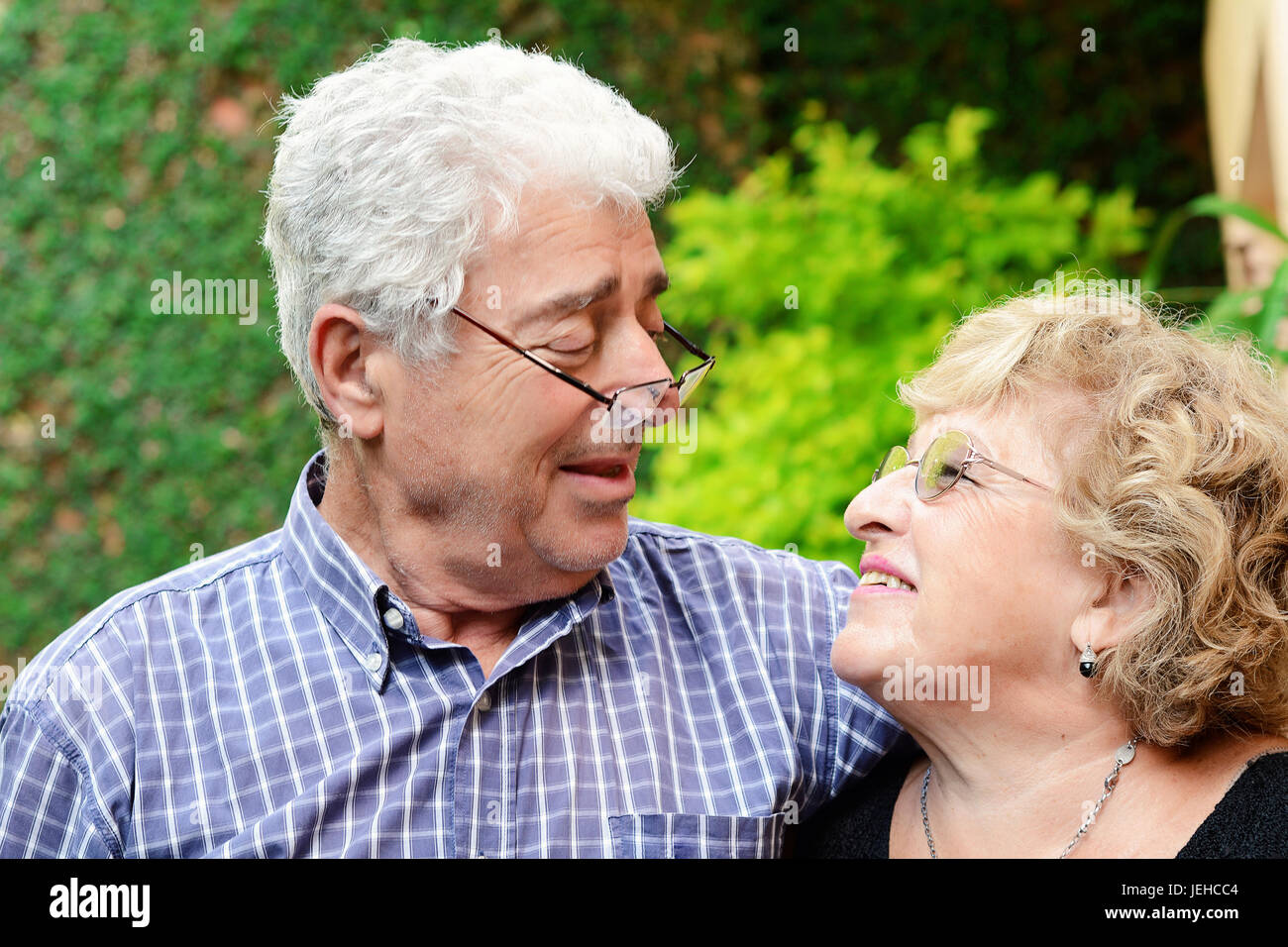 Portrait of an elderly couple sitting outdoors Stock Photo - Alamy