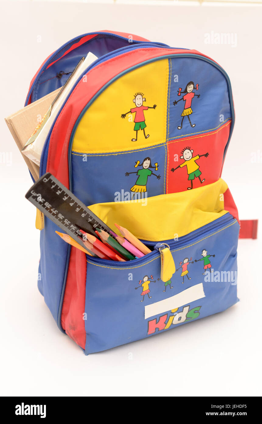 School backpack with accessories on a light background Stock Photo Alamy