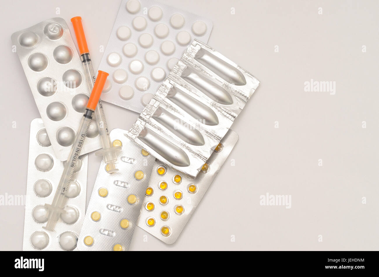 Contraceptive tablets in packages and without on a light background. Stock Photo