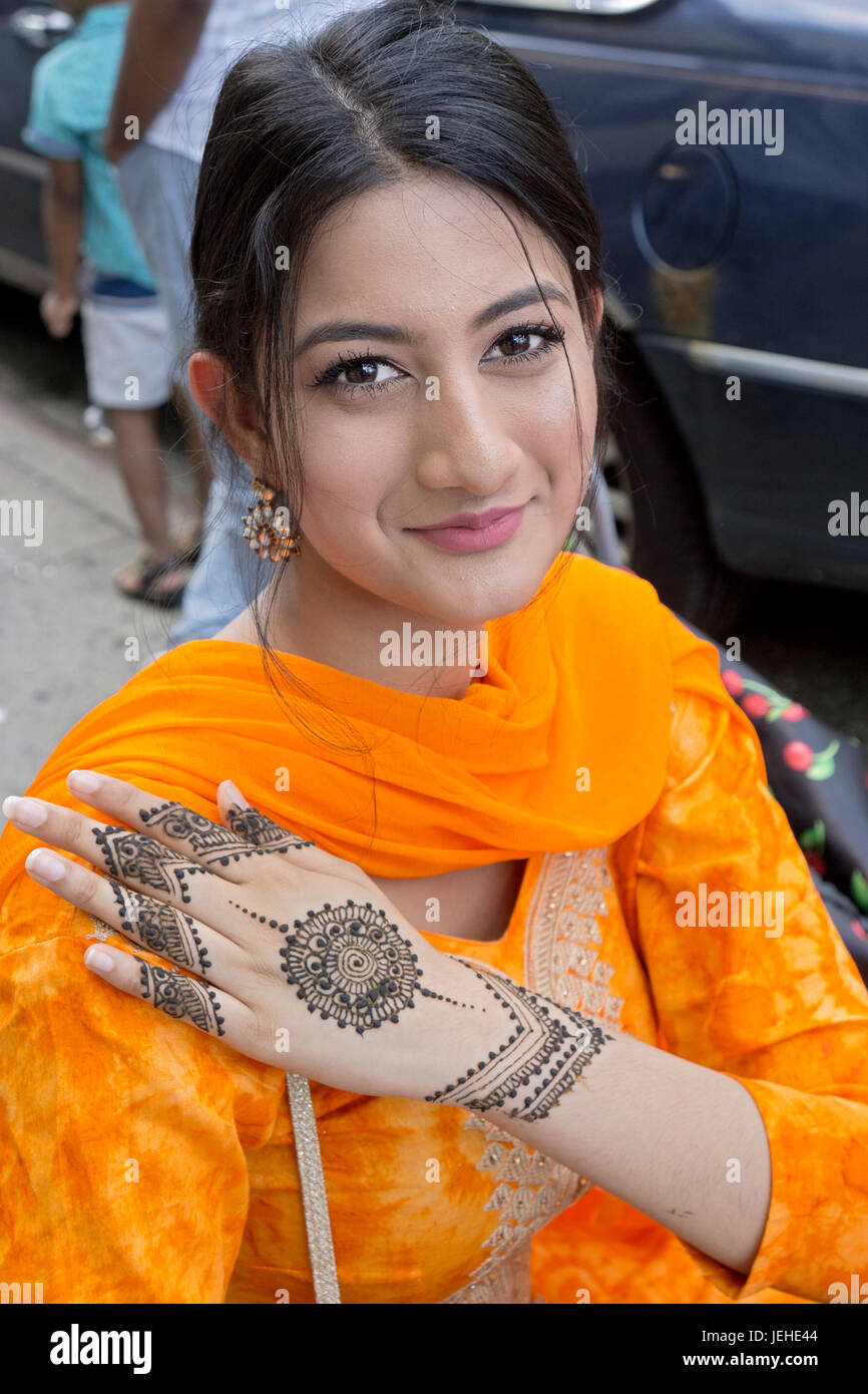 A beautifal Islamic Indian young lady shows her henna markings to celebrate Eid Al Fitr holiday marking the end on Ramadan. In Jackson Heights, Queens Stock Photo