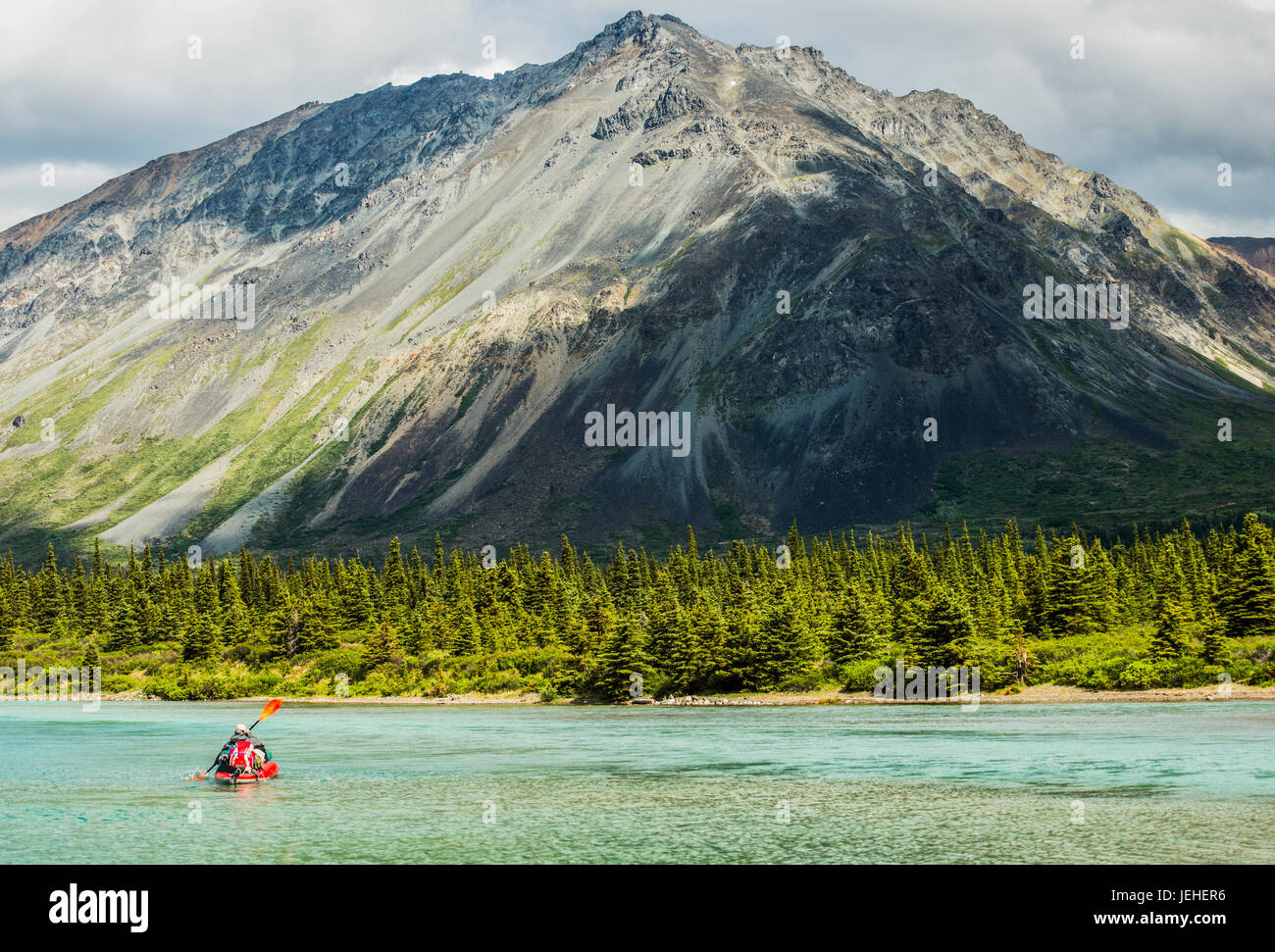 A kayaker paddles across one of the Twin Lakes in Lake Clark National Park & Preserve, Southcentral Alaska, USA Stock Photo