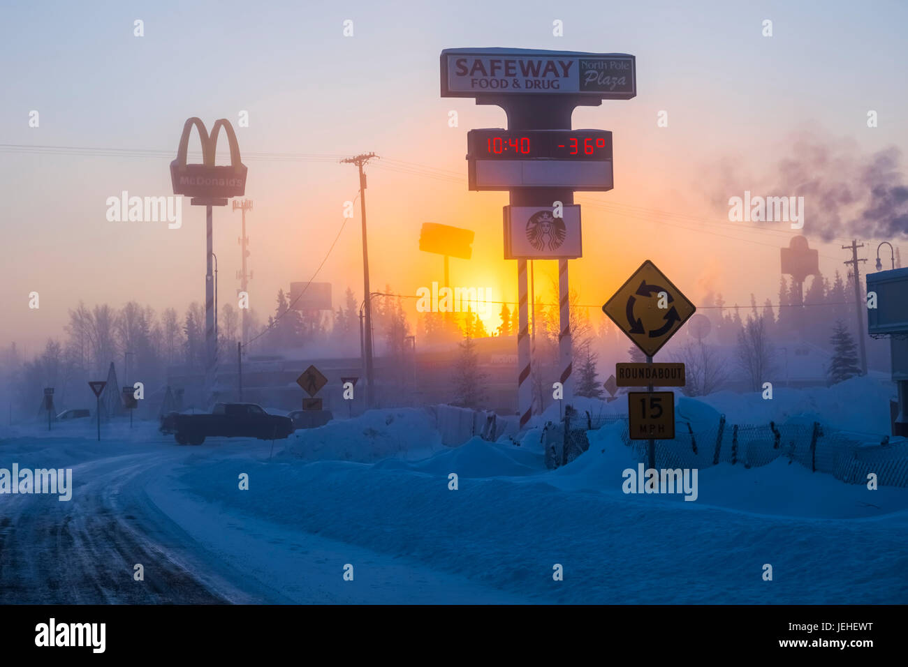 The sun rises behind Santa Claus Lane in North Pole, Alaska on a frigid morning in January. Stock Photo