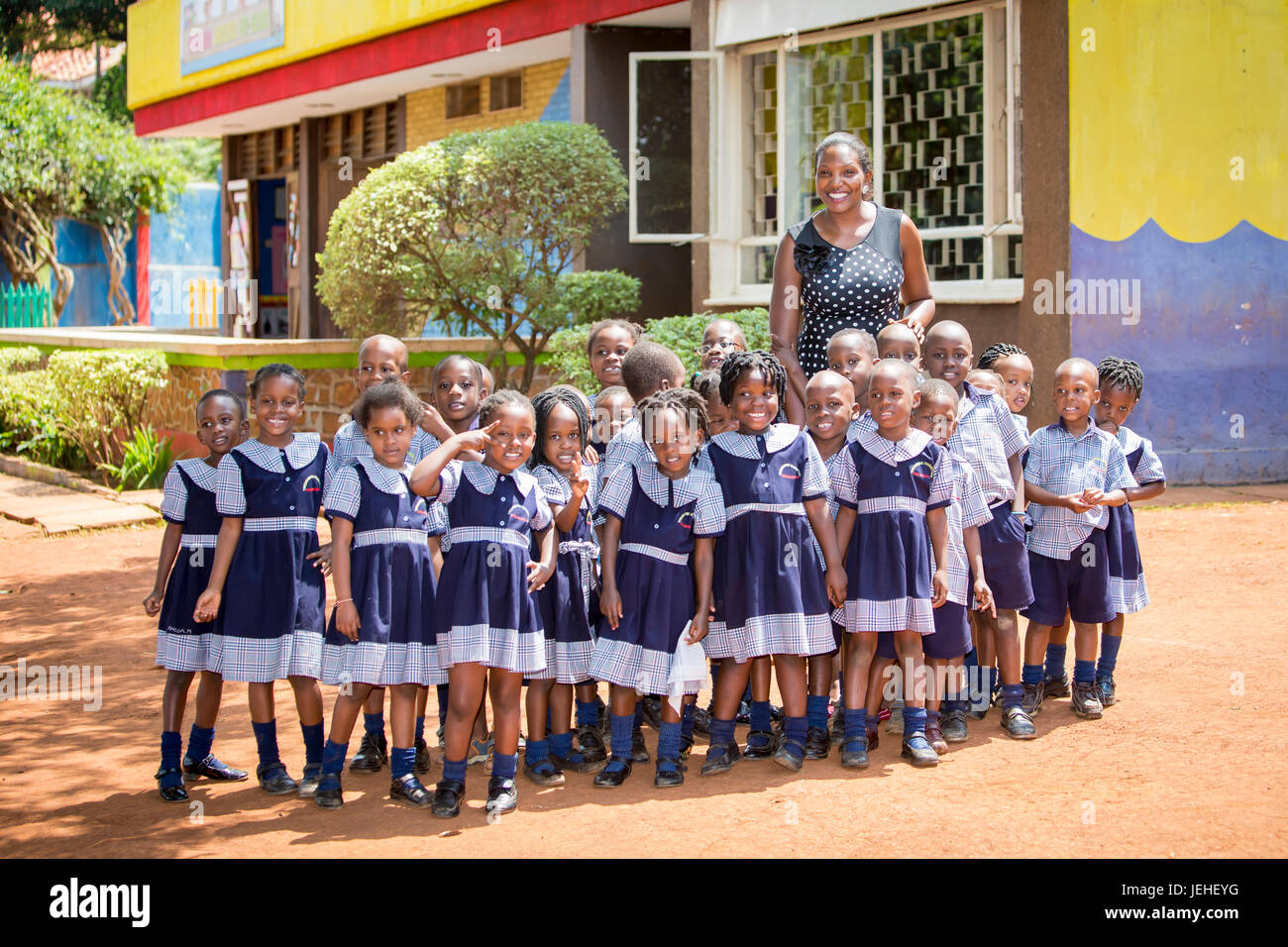 Portrait of a teacher with her early education students at Treasures Christian Preschool; Kampala, Uganda Stock Photo