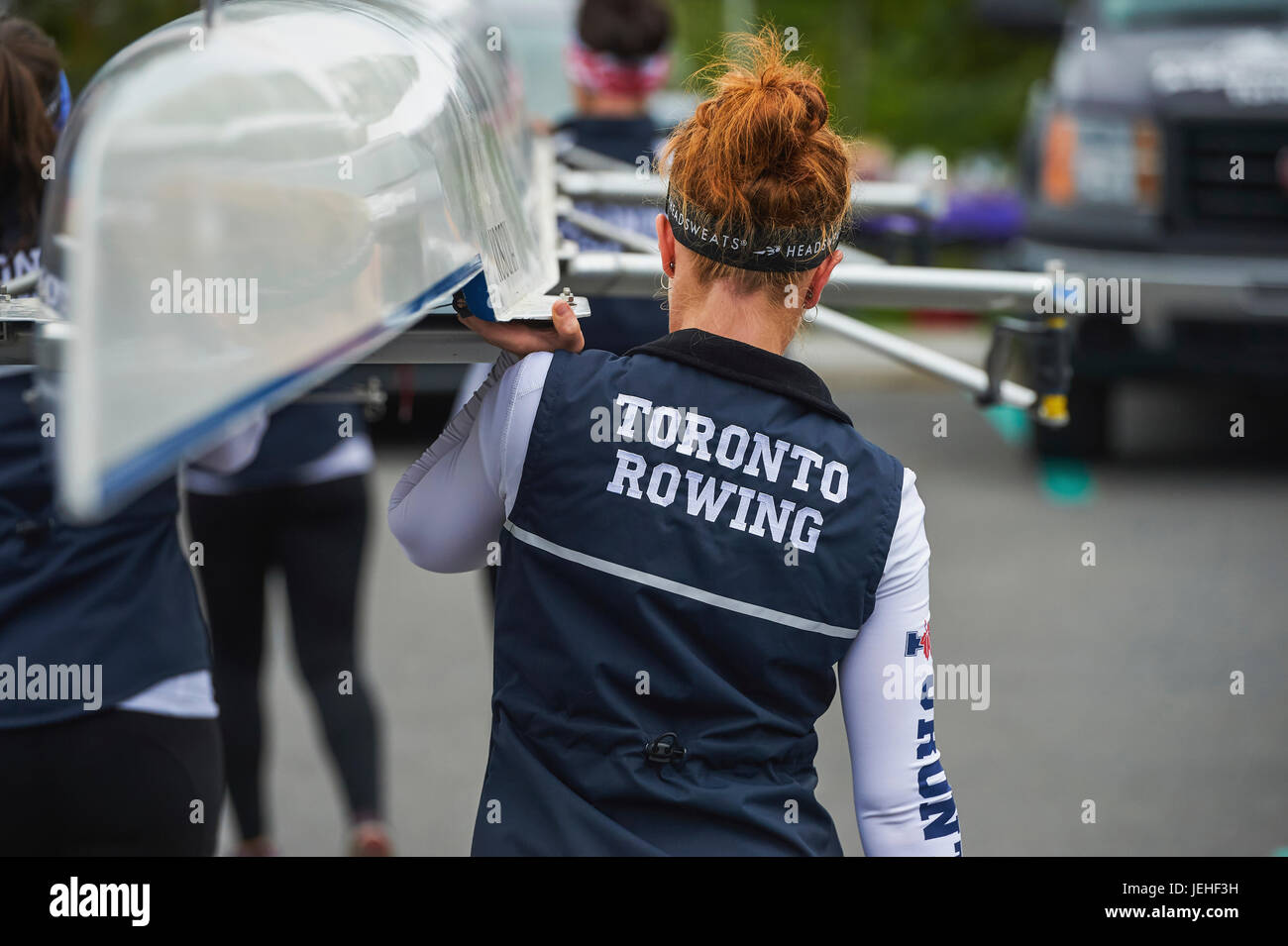University of Toronto women's crew carrying their boat to the water for the Head of the Trent regatta; Ontario, Canada Stock Photo