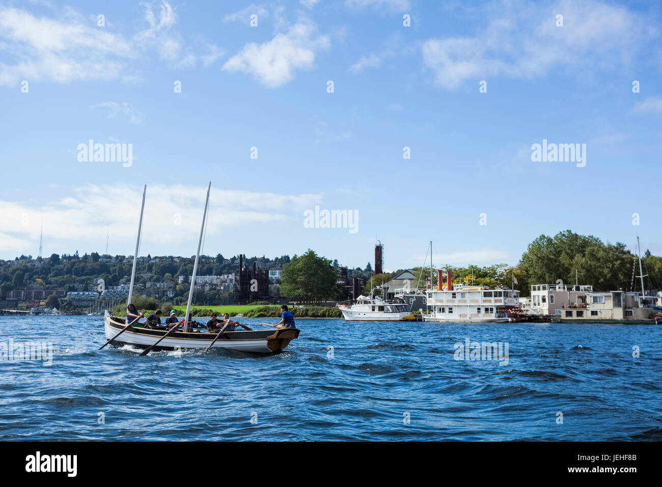 A rowing team rowing a boat in a harbour; Vancouver, British Columbia