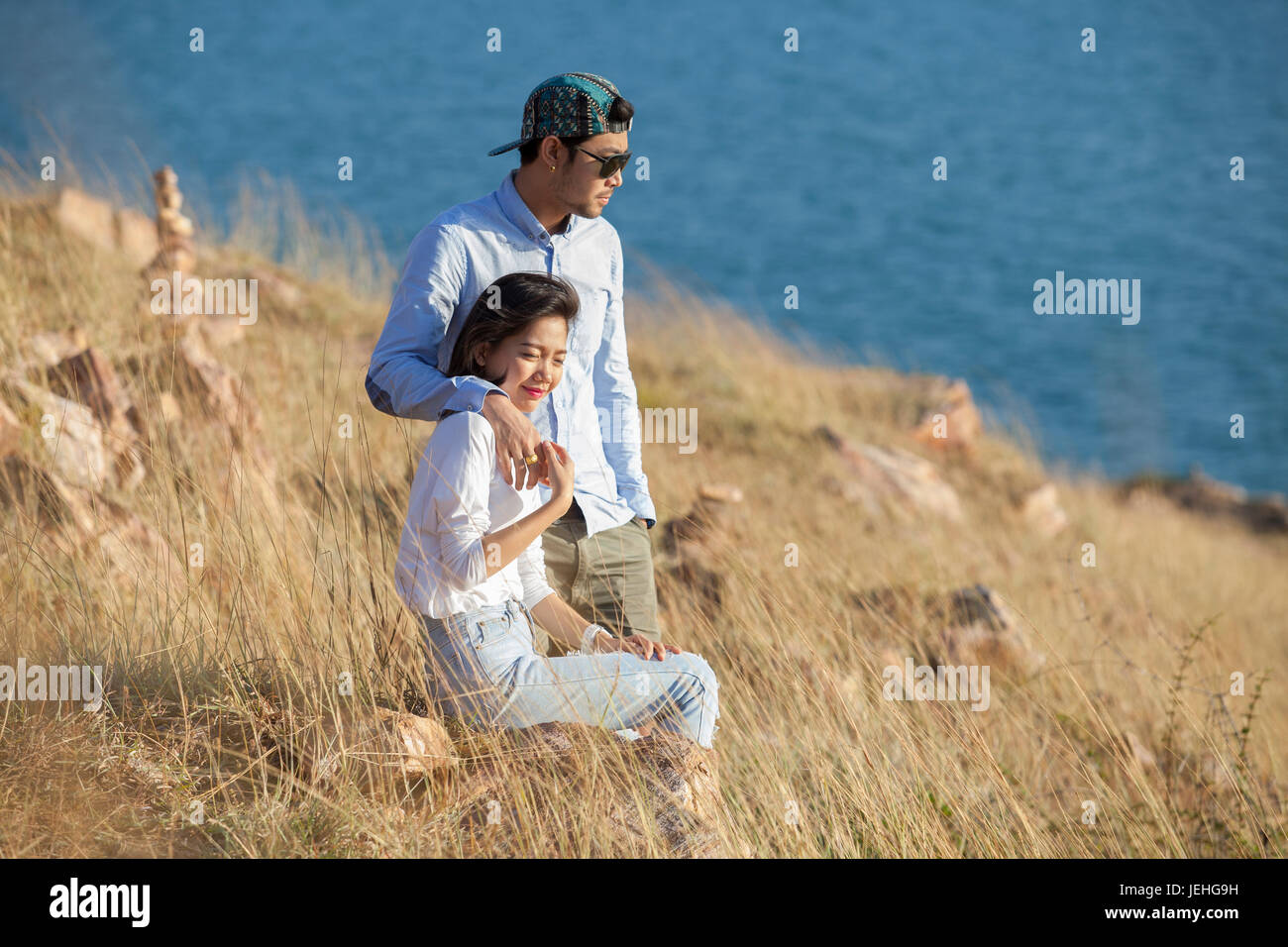 portrait of asian younger man and woman relaxing vacation at sea side happiness emotion Stock Photo