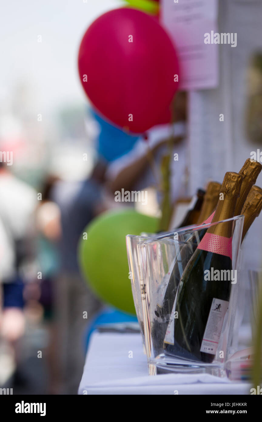 Bottles of champage and a red and  green balloon outside at a street party in Marlyebone London, UK in June 2017 Stock Photo