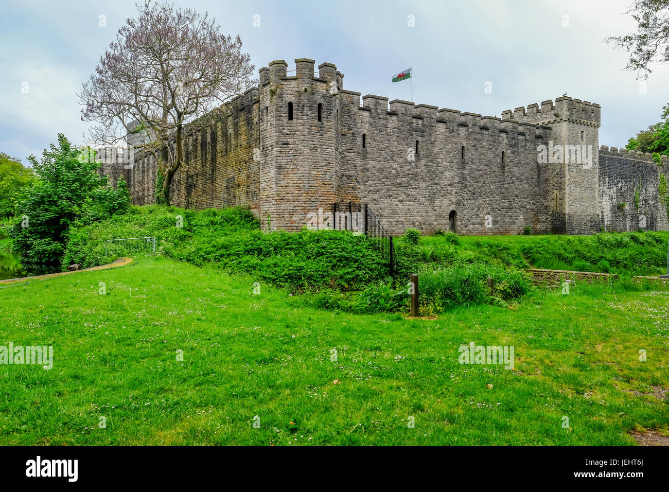 Cardiff, Wales - May 20, 2017:  View of Cardiff Castle from Bute Park, with Welsh flag flying high. Stock Photo