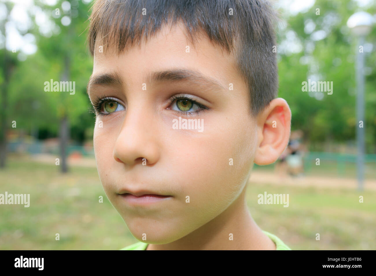 Green eyes boy smiling the park Stock Photo - Alamy