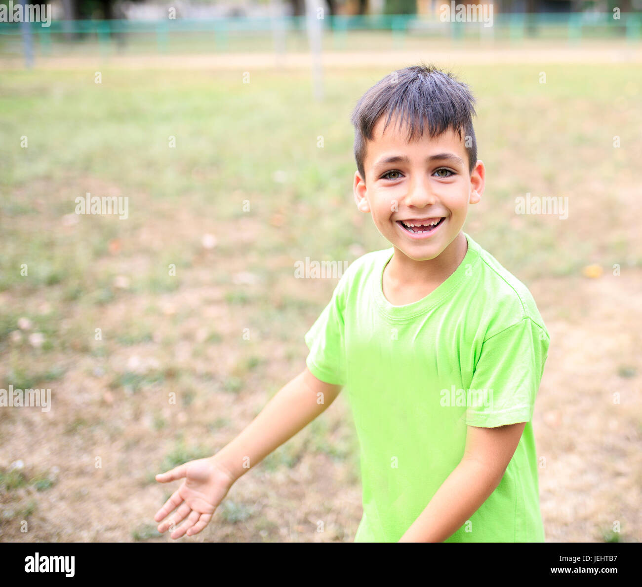 Green eyes boy smiling the park Stock Photo - Alamy