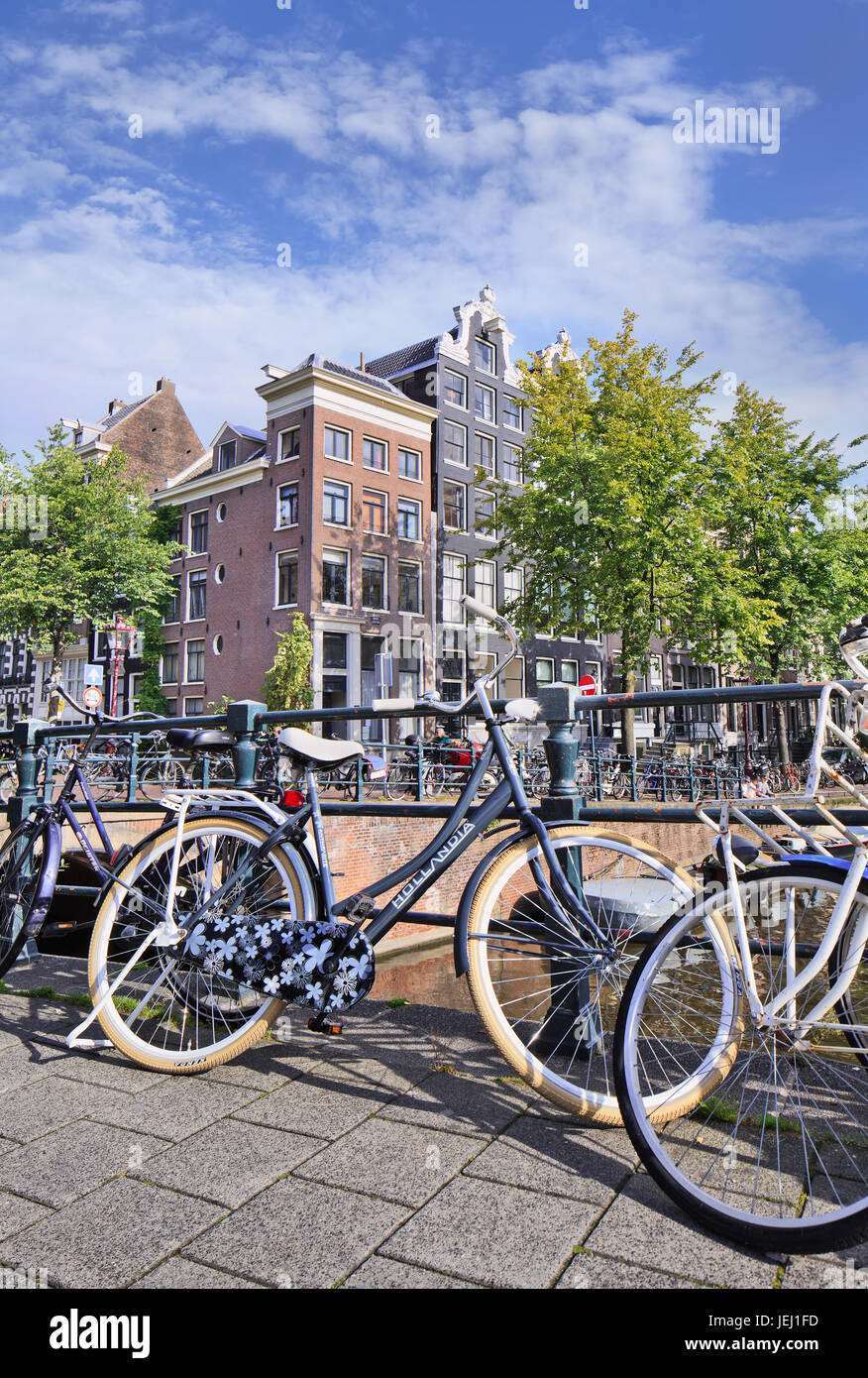 AMSTERDAM-AUG. 27, 2014. Hollandia bike parked against railing. Hollandia (1886) is a Dutch brand. Most important of Dutch bikes is upright position. Stock Photo