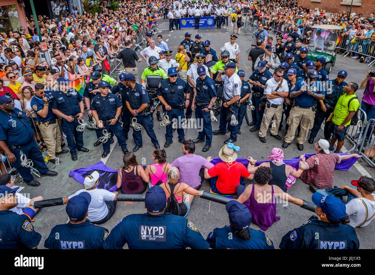 New York, United States. 25th June, 2017. Queer and trans allies, part of the No Justice No Pride movement blocked the NYPD and Toronto Police contingents at the New York City Pride March in pride for Trans and Queer lives. Protesters chained themselves to one another bringing the march to a complete halt. Twelve arrests were made co-facilitated by the Pride March board of directors for blocking police presence out of pride. Credit: Erik McGregor/Pacific Press/Alamy Live News Stock Photo