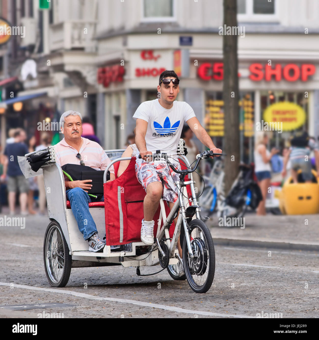 AMSTERDAMAUG. 19, 2012. Bike taxi with passengers at Dam Square