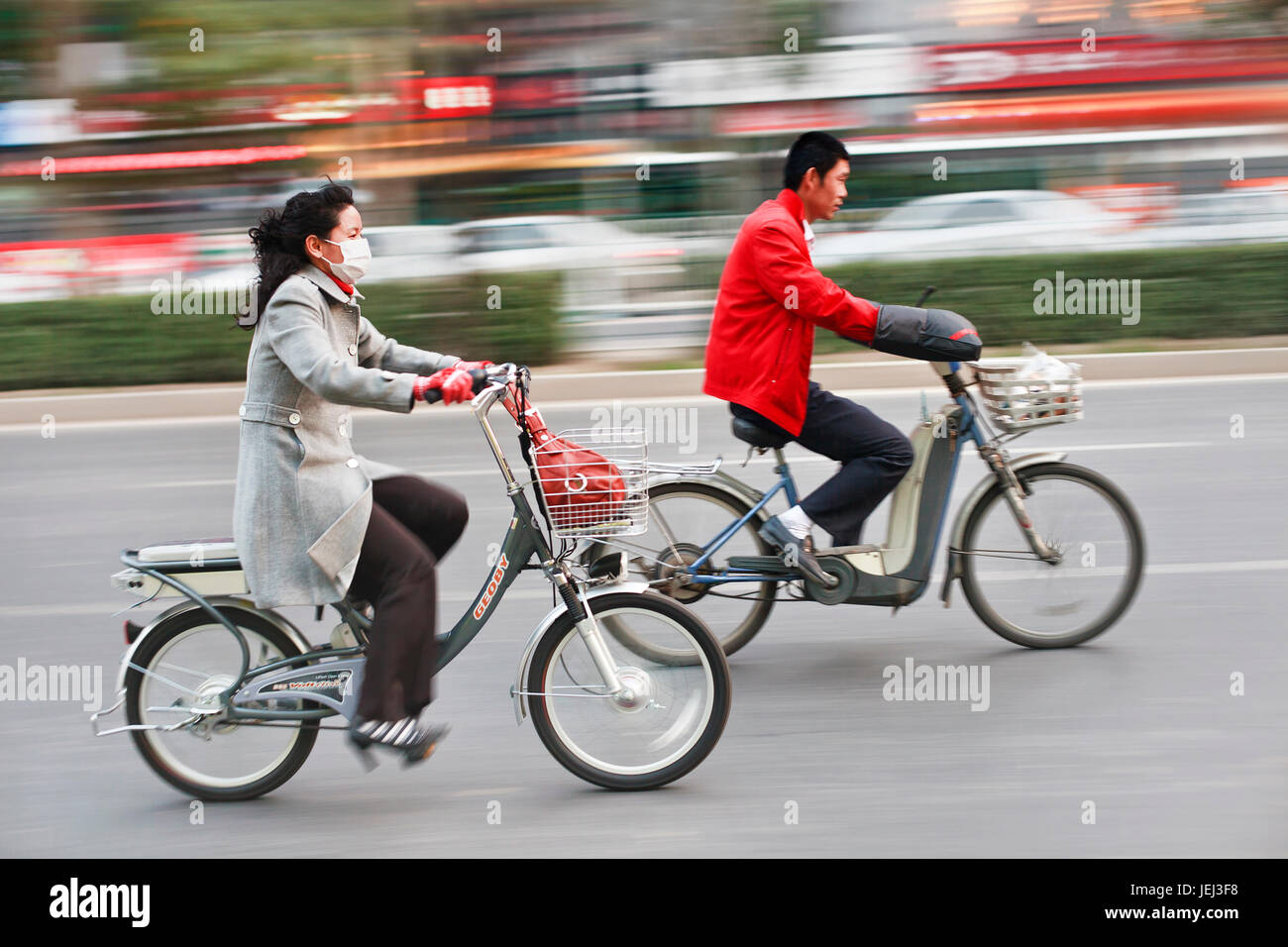 BEIJING–OCT. 28. Beijing citizens on e-bikes. At least 120 million e-bikes are already on Chinese roads, and sales are only growing. Stock Photo