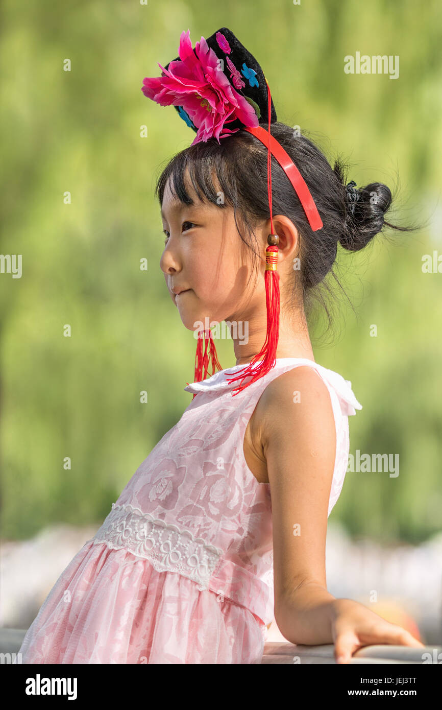 BEIJING-AUGUST 14, 2016. Cute young Chinese girl poses for a photo. China has scrapped its one-child policy and allow couples to have two children. Stock Photo