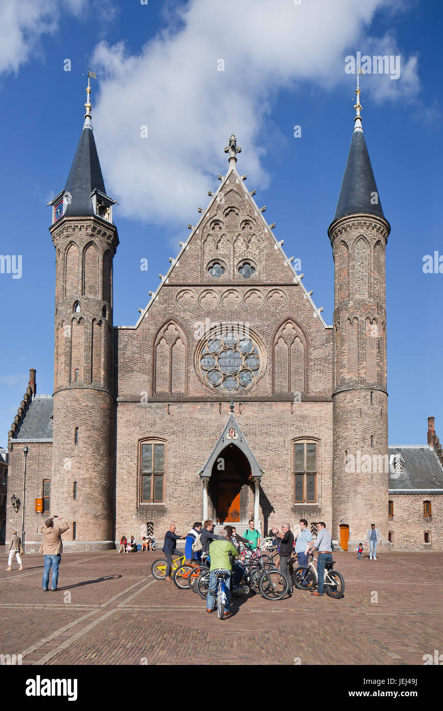 THE HAGUE-AUG. 23, 2014. Cyclists at in front of Ridderzaal, main building of medieval Binnenhof, used for state opening of Parliament on Prinsjesdag. Stock Photo