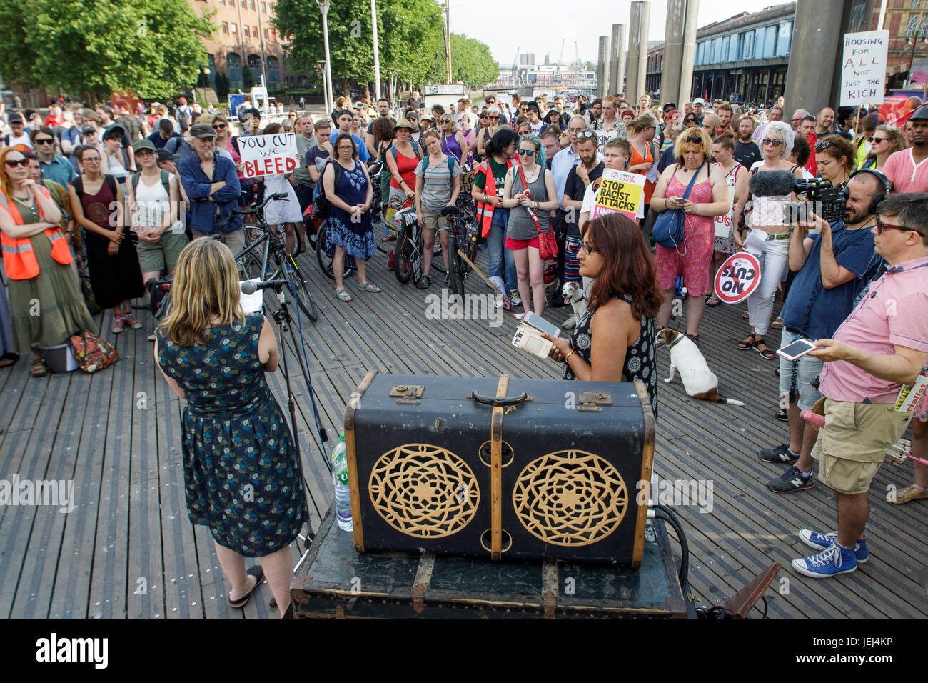 Protesters carrying placards are pictured listening to speeches before taking part in a Austerity kills,Justice for Grenfell protest march in Brisol. Stock Photo