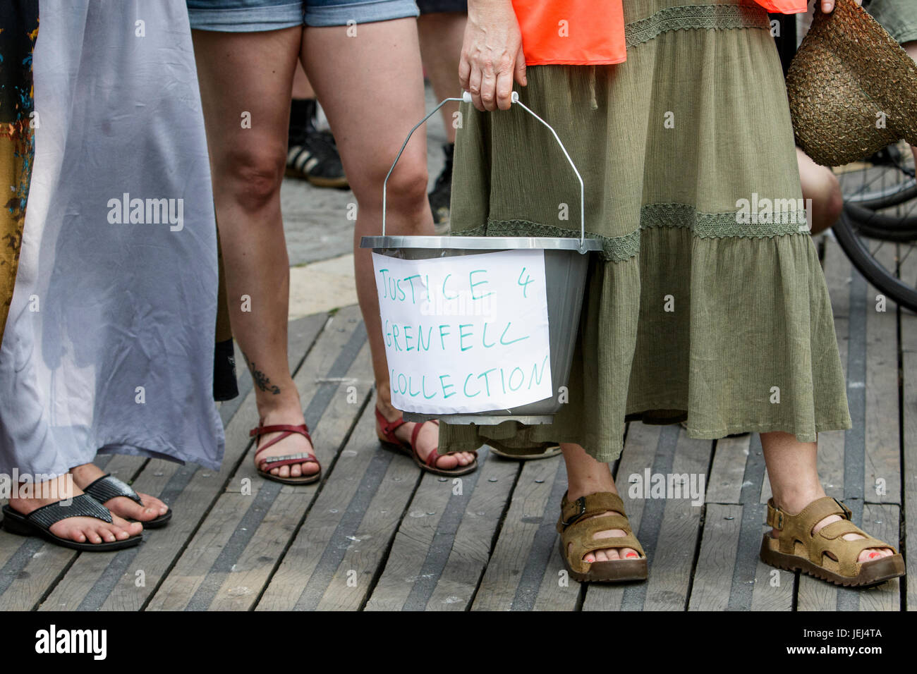 A collection bucket for donations for the Grenfell residents is pictured before the start of the Austerity kills,Justice for Grenfell march in Bristol Stock Photo