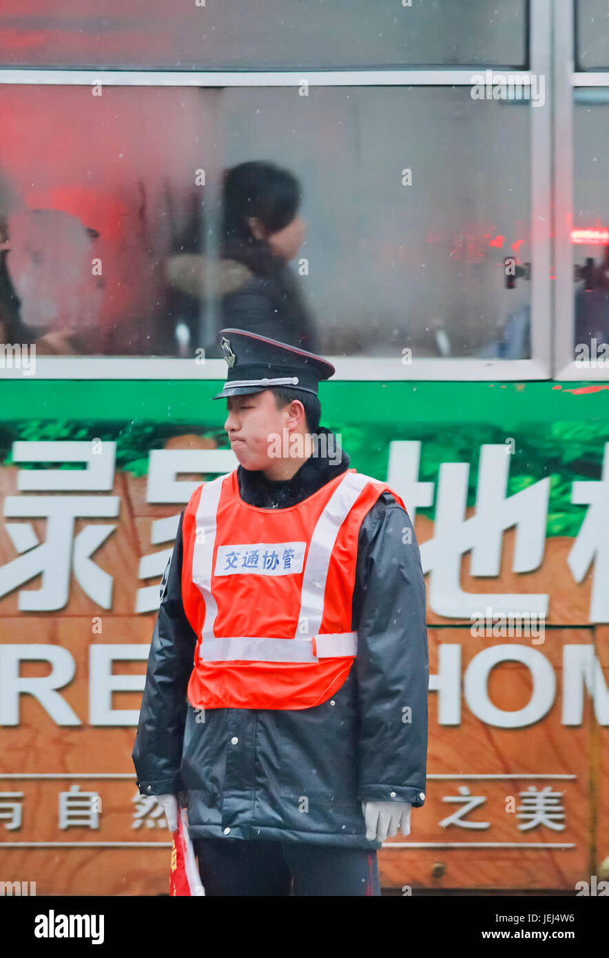 HEFEI-CHINA-JAN. 6, 2009. Distressed policeman on an early rainy morning. Unlike US or Hong Kong police, most policemen in China don not carry guns. Stock Photo