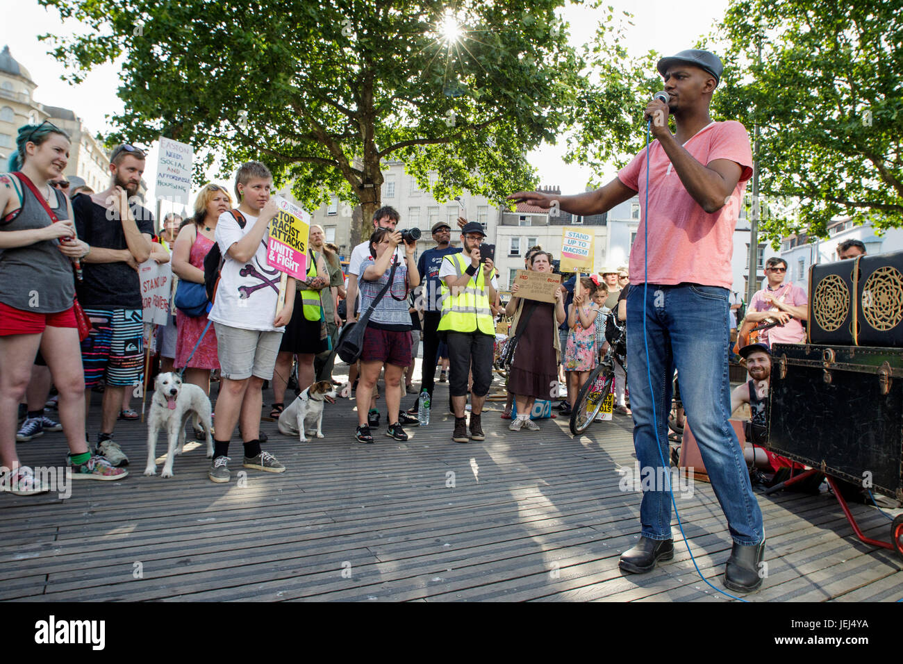 Anti-racist campaigner Kamal Mohamed is pictured speaking to protesters before a Austerity kills, Justice for Grenfell protest march in Bristol Stock Photo